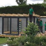 Workers constructing a Composite Garden Building