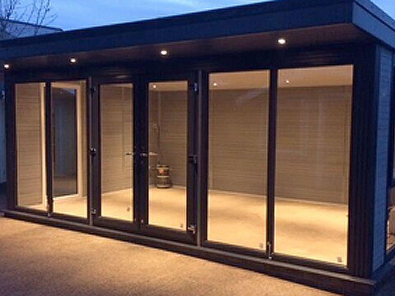 Well lit Composite garden room at night