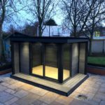 Centered Composite Garden Building With Lit Up Interior